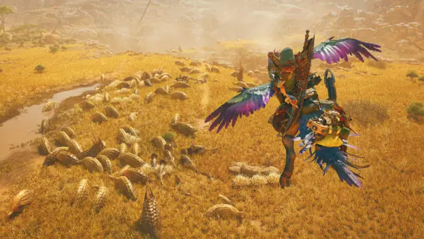 Łowca na wierzchowcu na pustyni w grze Monster Hunter Wilds