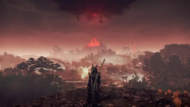Wojownik na skale nad doliną w czerwonym świetle w grze Nioh 3